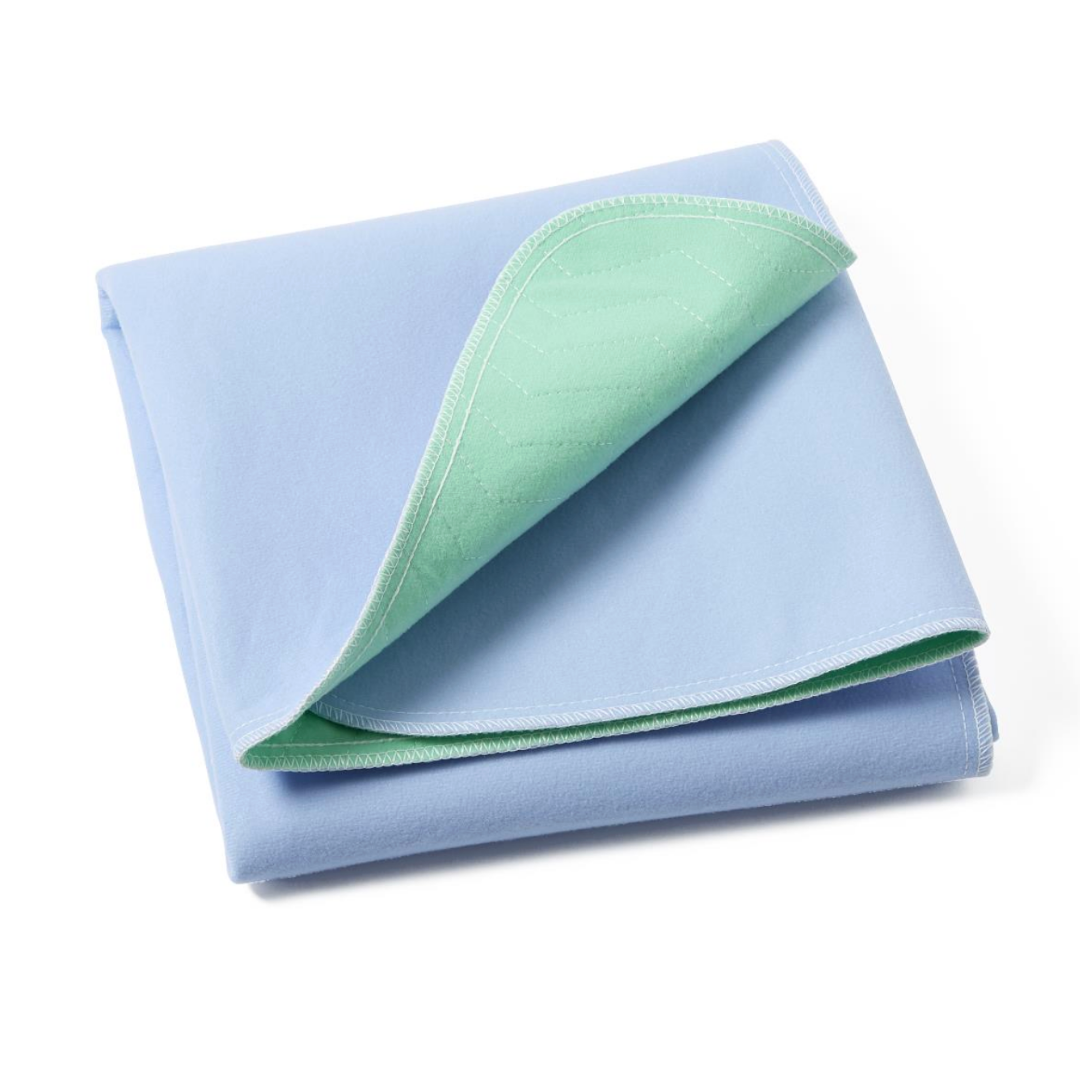 The Medline Quick Dry Poly Laminated Reusable Underpad, 34 x 36, is shown neatly folded with a light blue top and light green underside. Its layered, absorbent advanced fiber blend is visible on a white background.